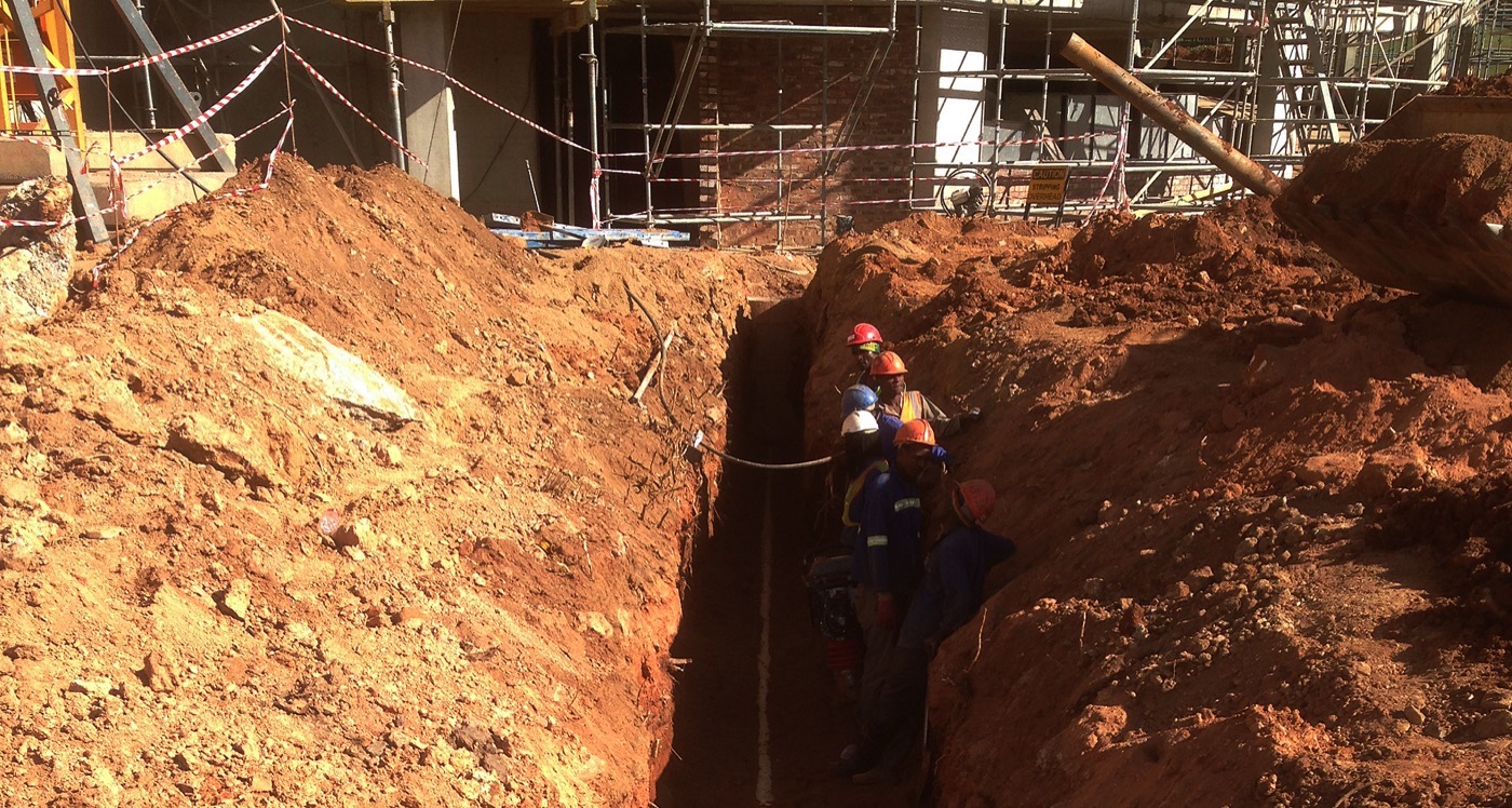 Deep excavation for underground plumbing on a commercial site